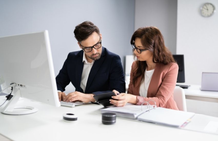 Girl showing calculator to man
