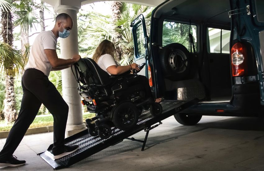 person helping disable person for travel