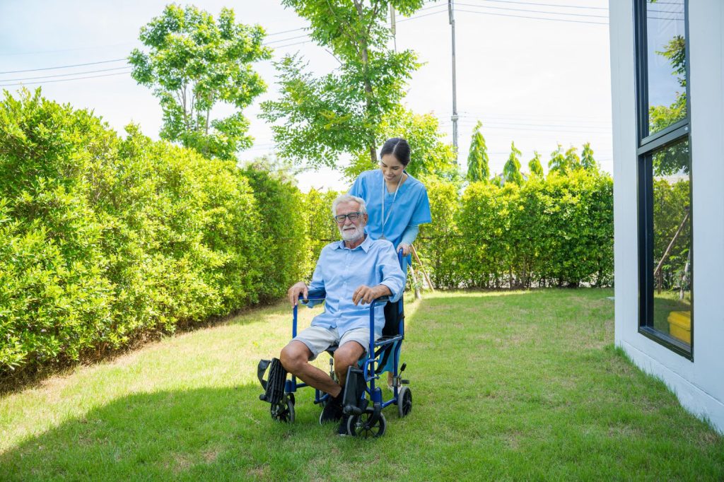 NDIS Nurse with participant sitting on wheelchair