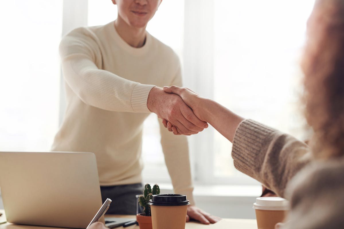 A business consultant discussing disability services registration costs with a client