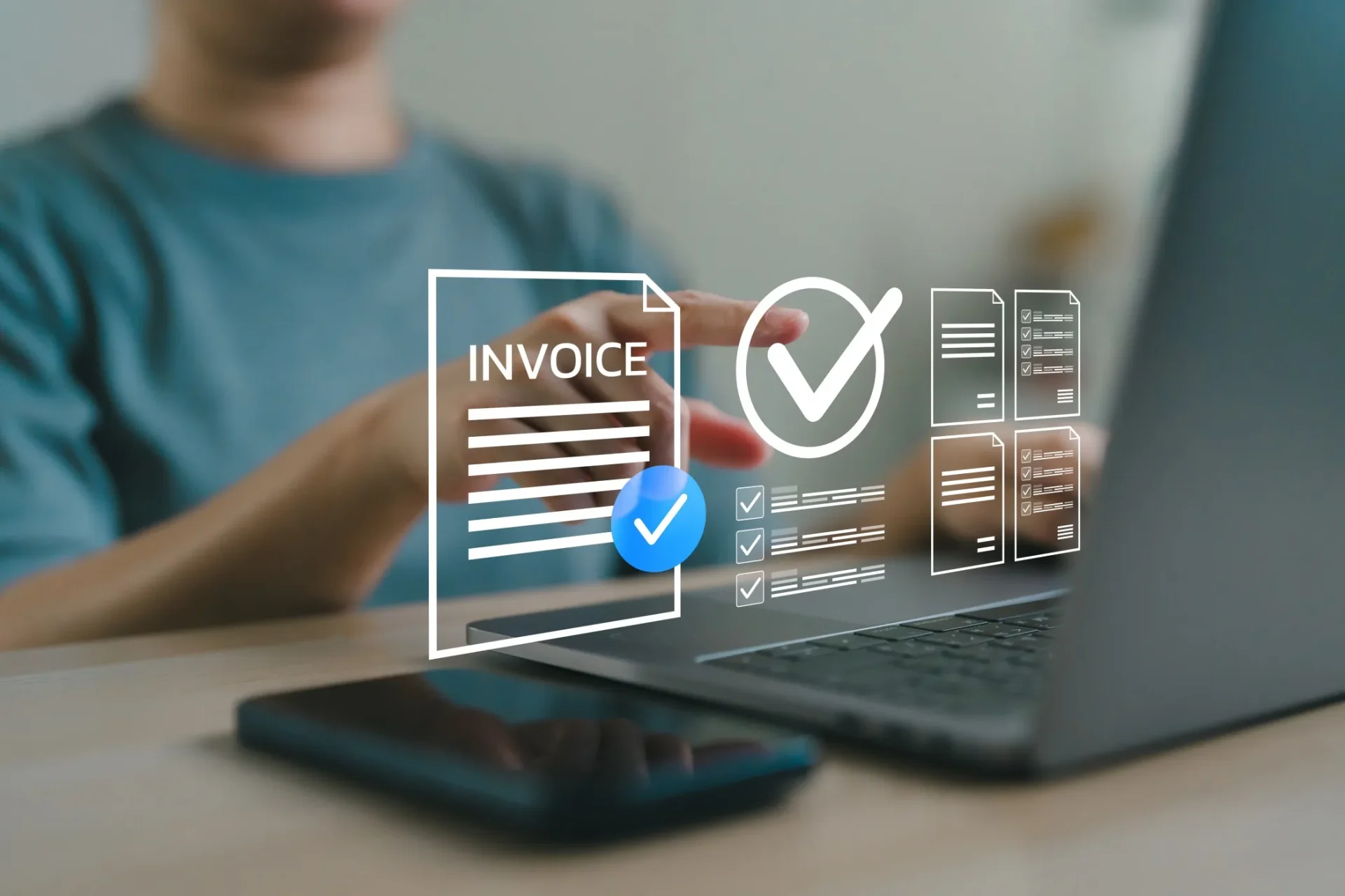 Close up of person processing invoices on laptop