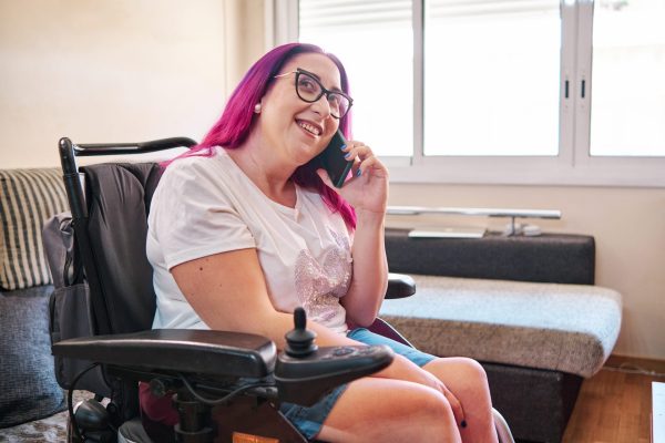 adult woman with disabilities using smartphone at home